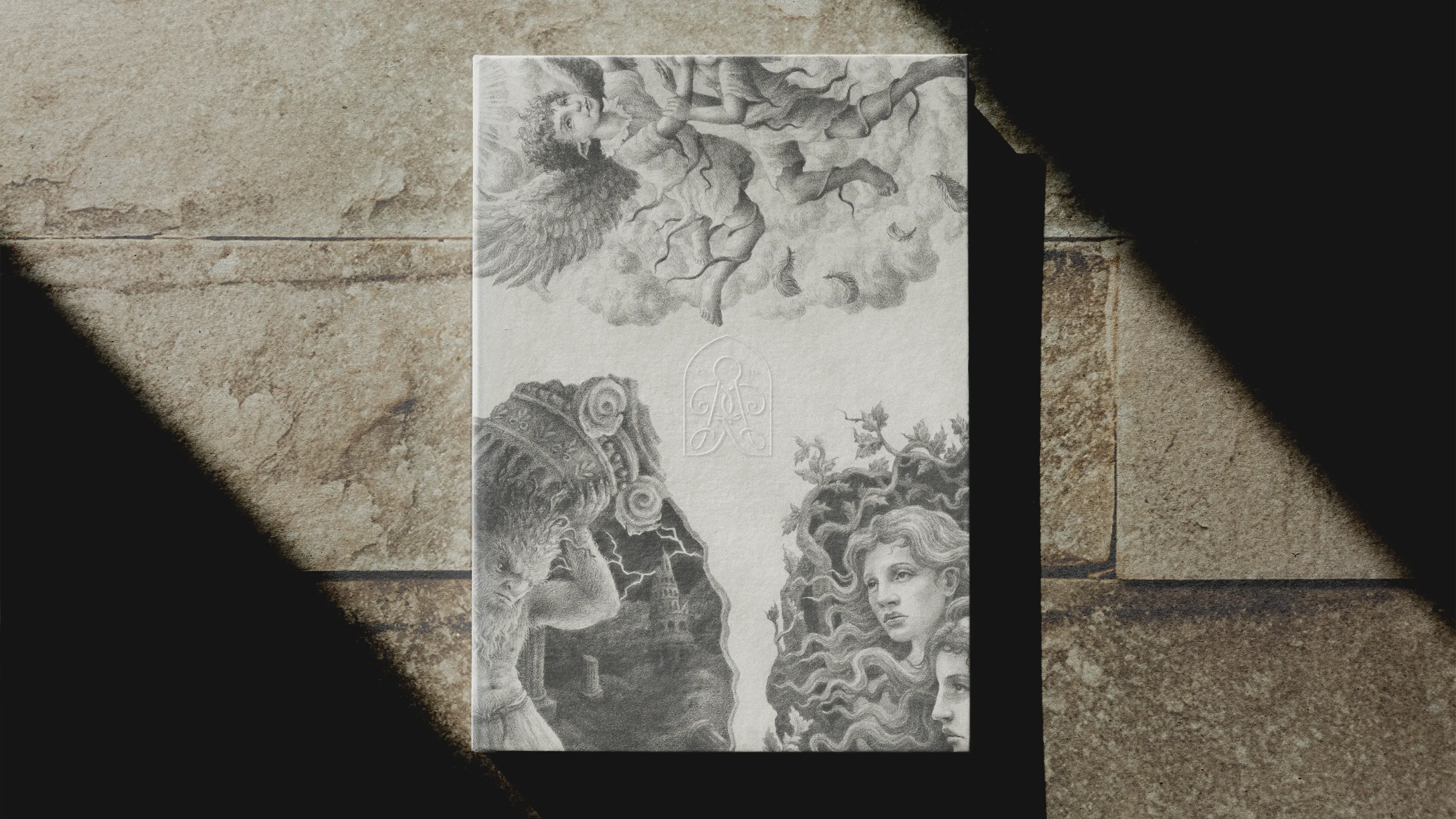 A Rudin branded illustration card lying on a worn stone surface under dramatic directional shadows. The card shows a large detailed pencil illustration of mythological figures — a winged creature, swirling clouds, cherubs, and a woman — with the Rudin monogram embossed in the centre