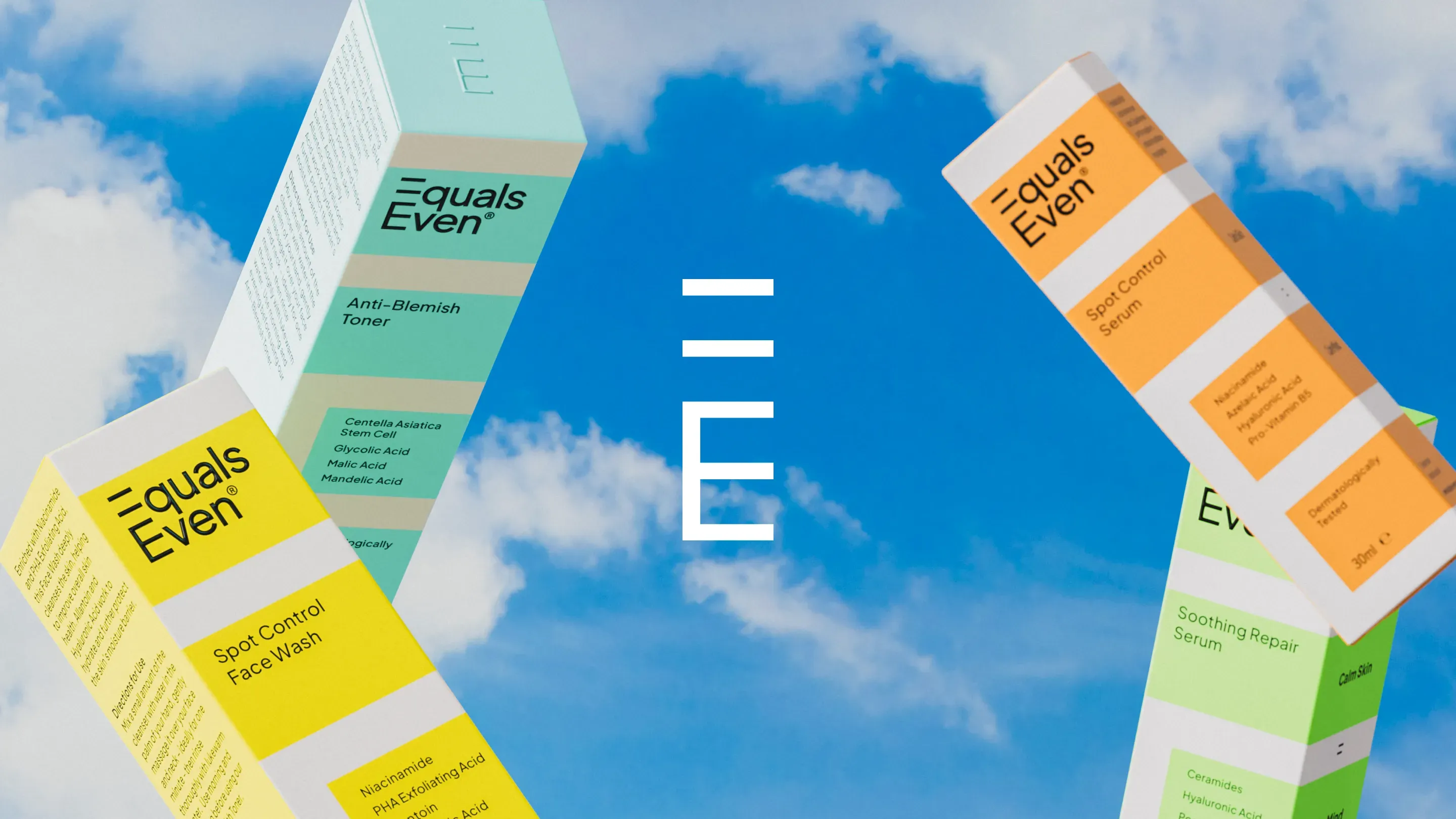 Four colorful Equals Even skincare packaging boxes appear to float against a bright blue sky with clouds, with the Equals Even logo in the center